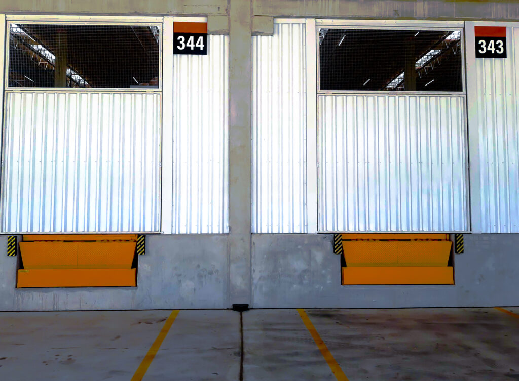 A pair of enclosed loading dock doors inside a warehouse.