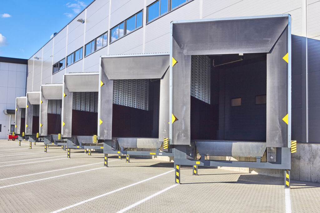 A series of sawtooth loading docks outside of a warehouse.