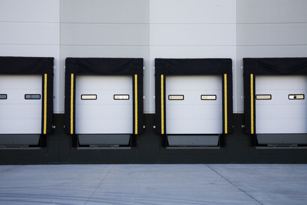 View of several loading docks attached to a facility with accompanying bumpers, levelers, lift, dock seals and shelters.